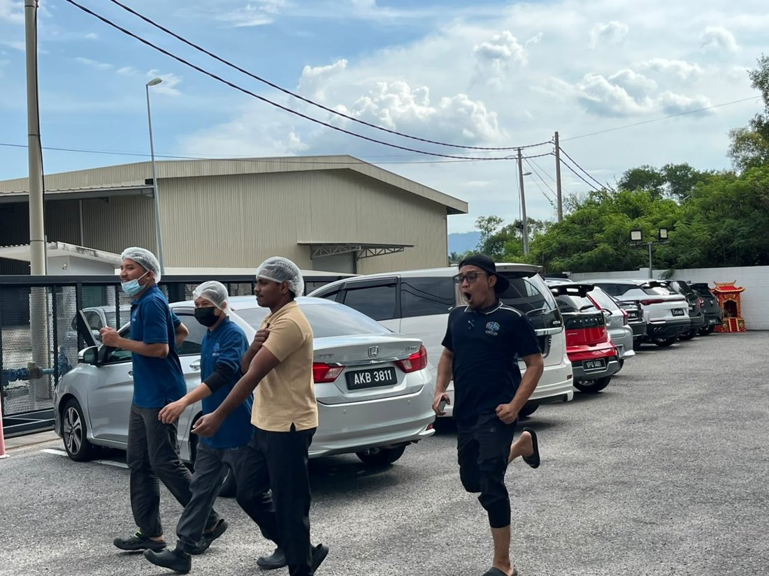 Dr Orizi production staff evacuating the building during the fire drill, still in hairnets