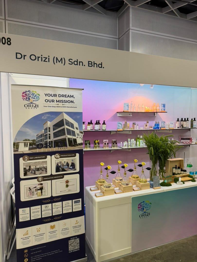 Booth 3008 at Cosmobeaute Malaysia 2026 KLCC with the Dr Orizi (M) Sdn. Bhd. fascia and ORIZI Group roll-up banner
