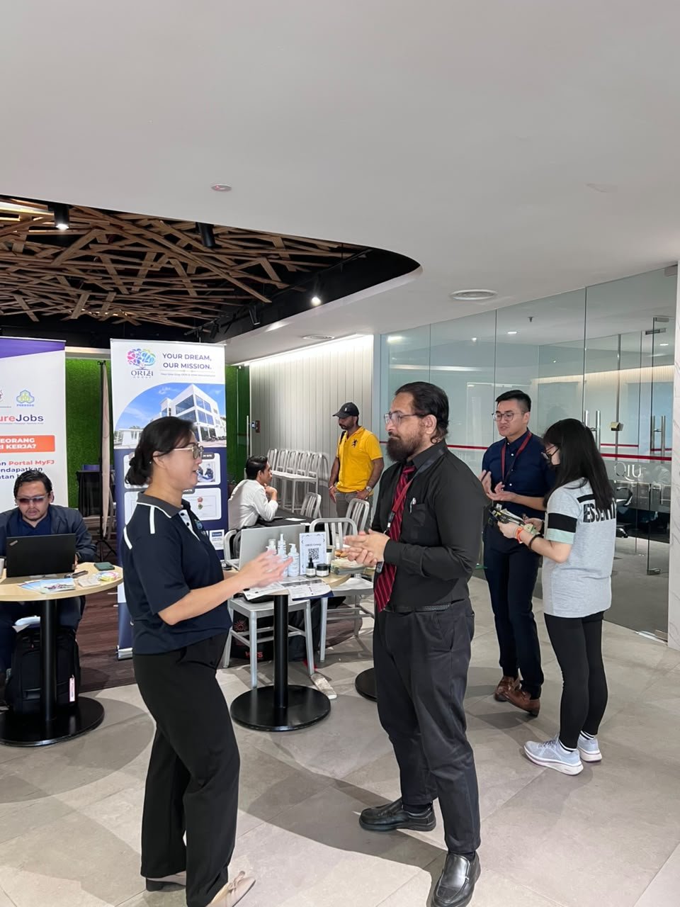 ORIZI Group team members speaking with visitors at QIU Industry Day 2026