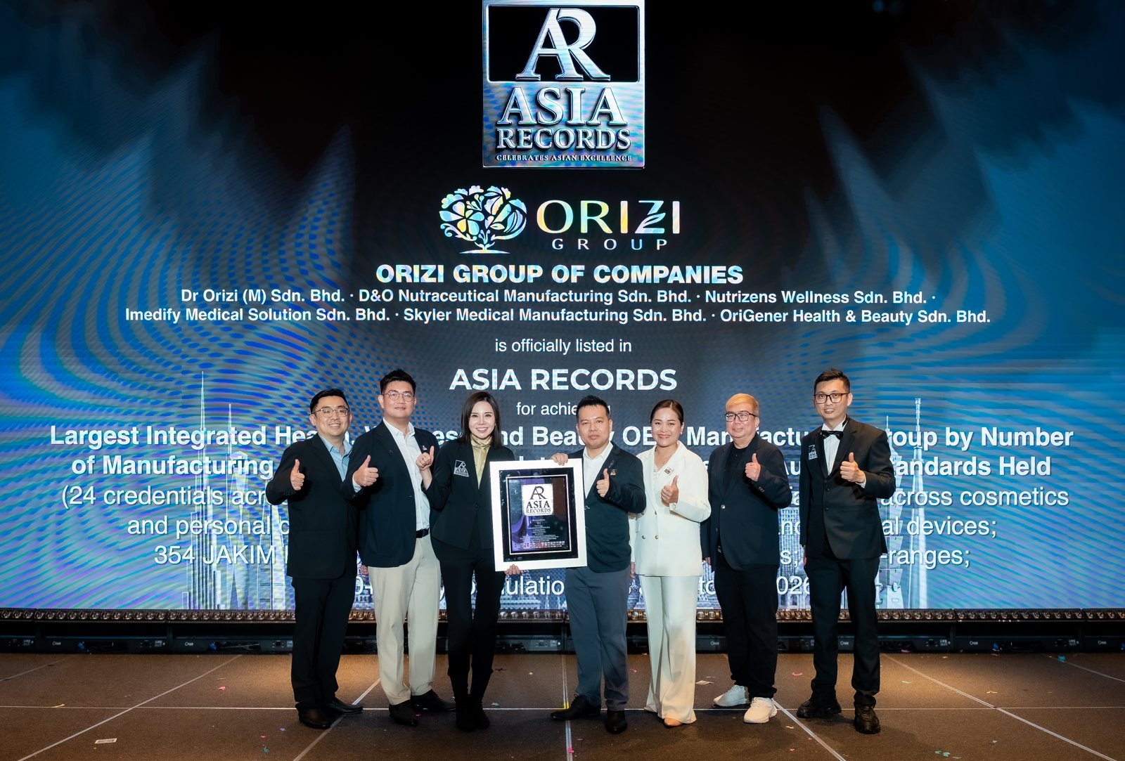 The ORIZI Group team on stage with the ASIA Records certificate, 20 October 2026.