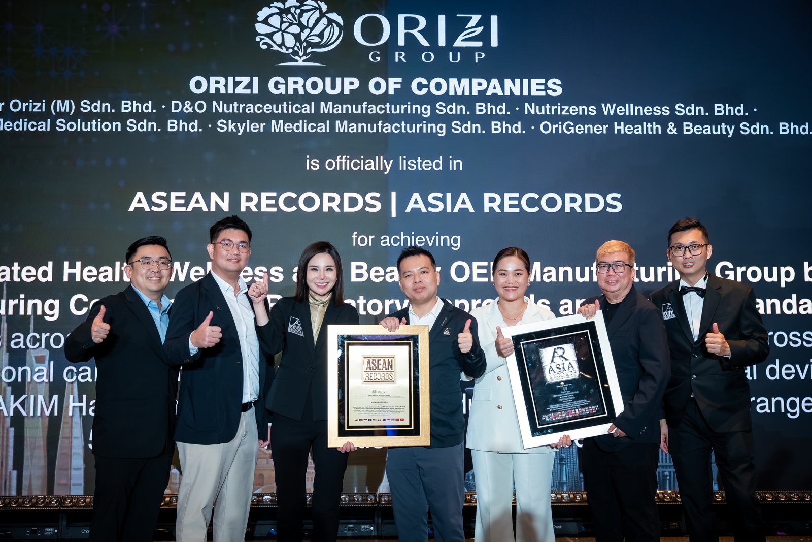 ORIZI Group team holding the ASEAN Records and ASIA Records certificates, 20 October 2026